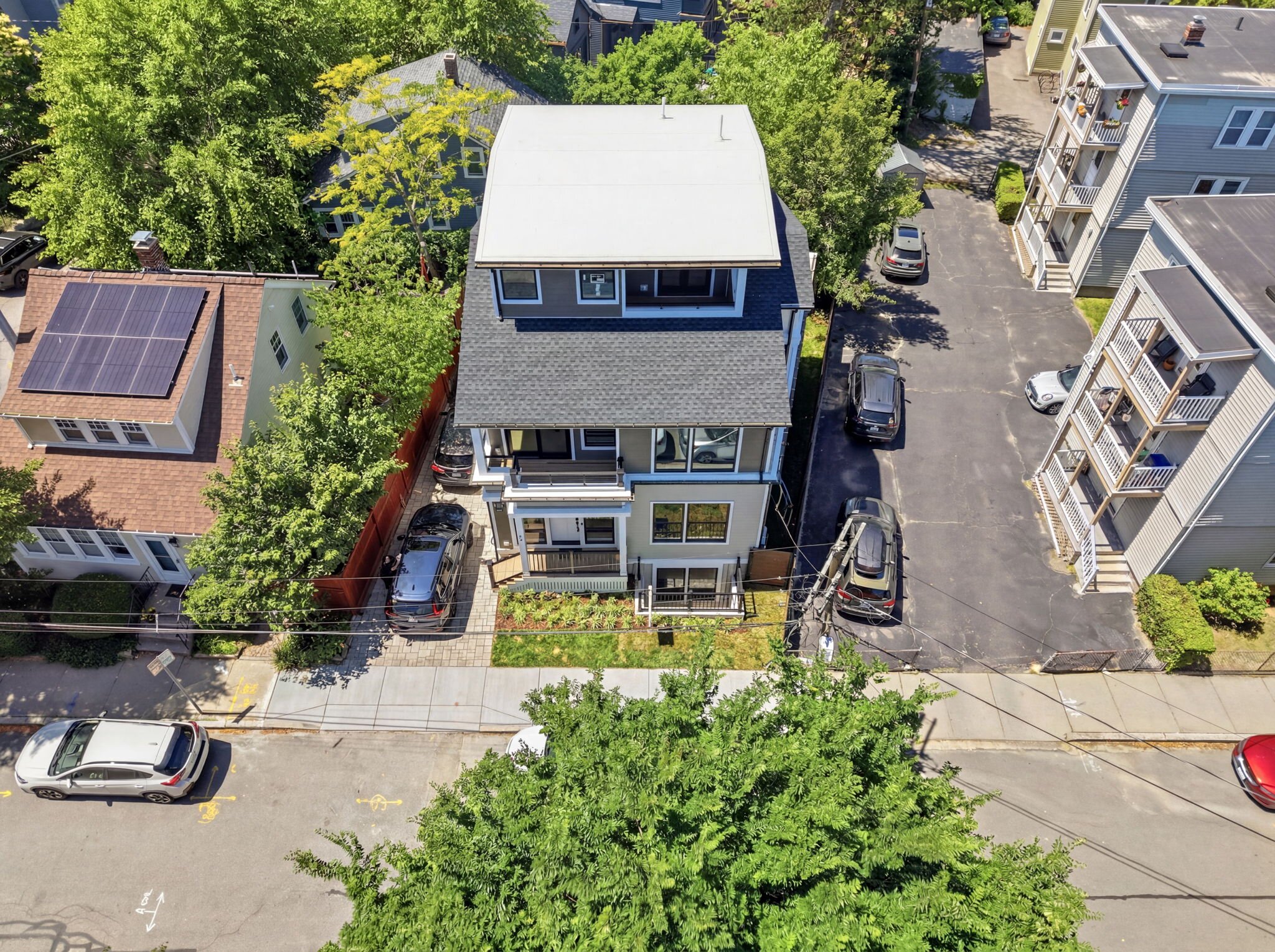 Drone view of the residence with rooftop solar