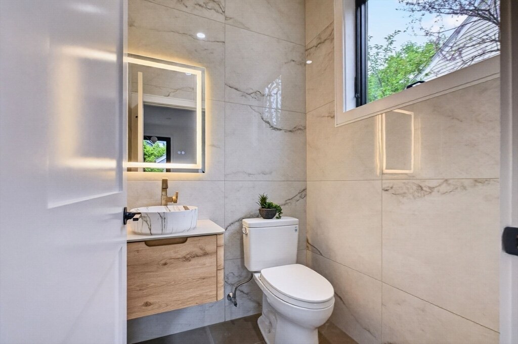 Stone-clad bath with a floating vanity
