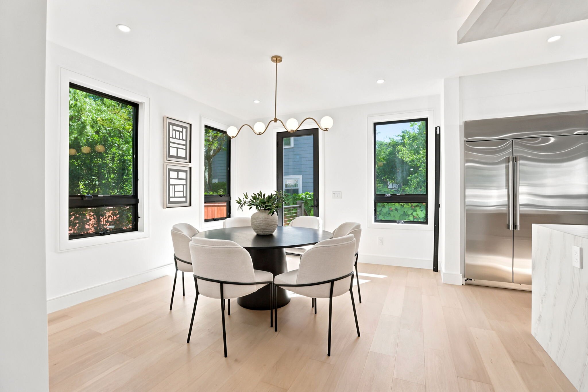 Dining area framed by floor-to-ceiling windows