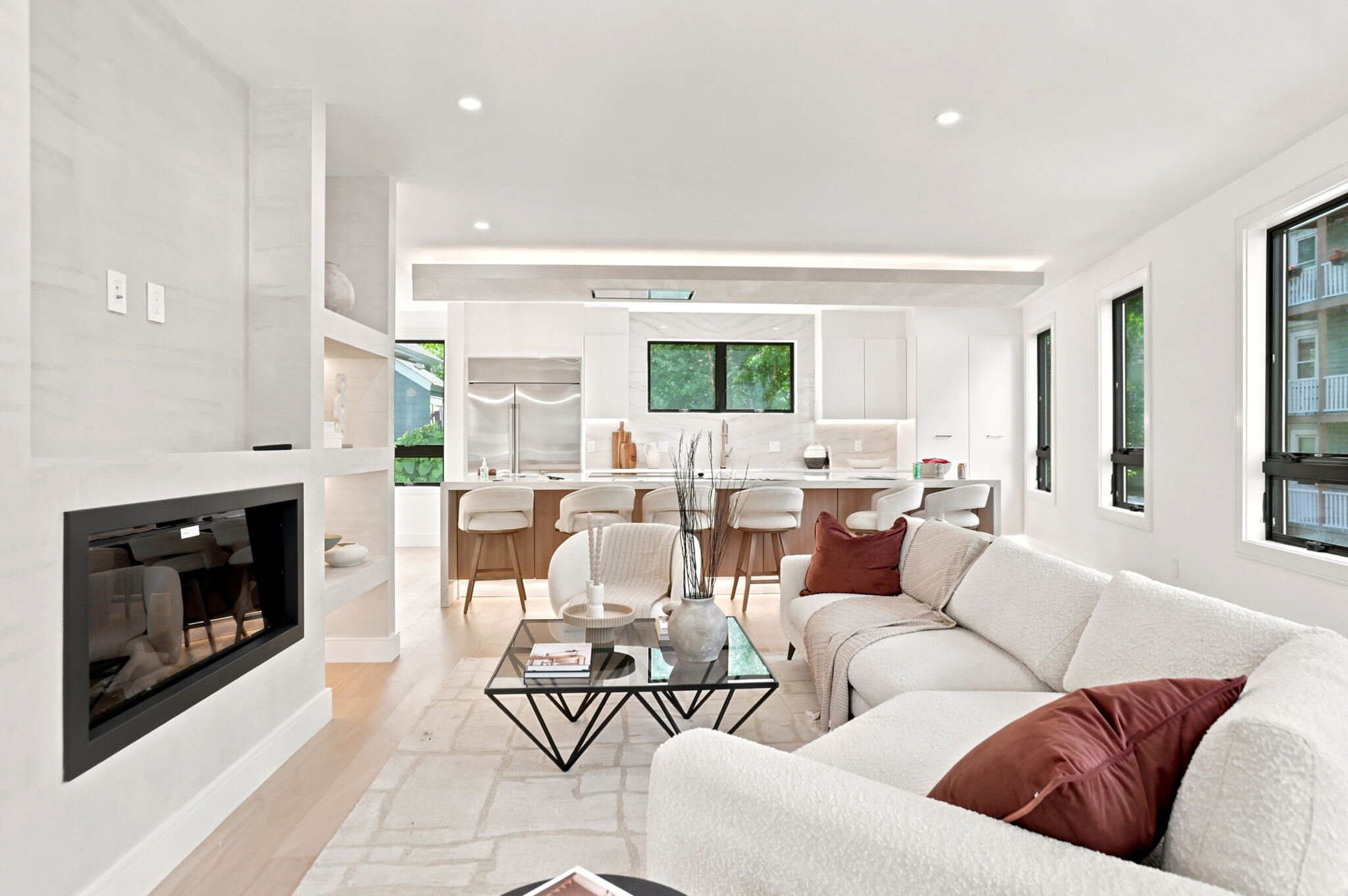 Great room with a linear fireplace flowing into the kitchen