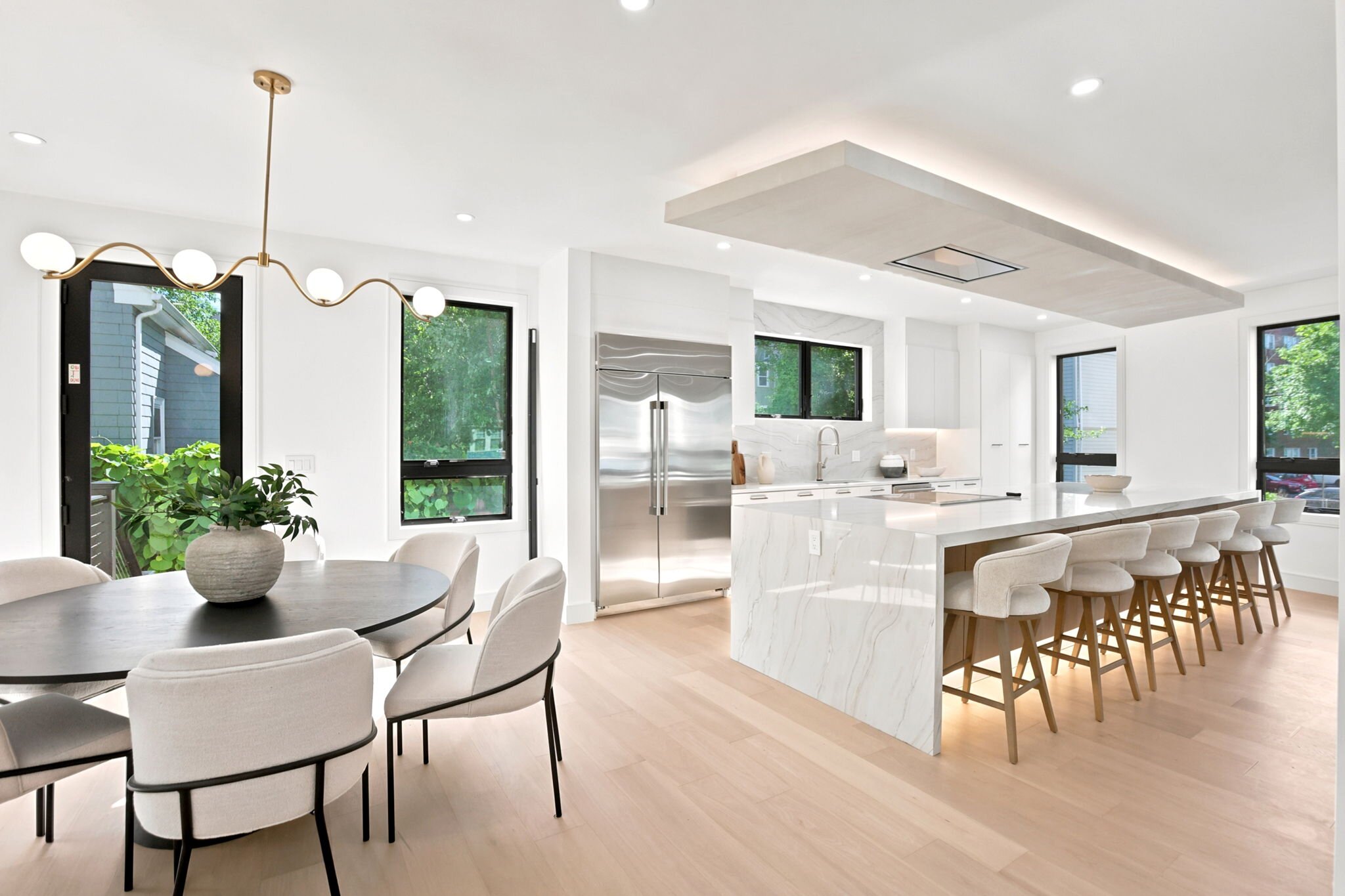 Kitchen open to the dining area with floor-to-ceiling windows