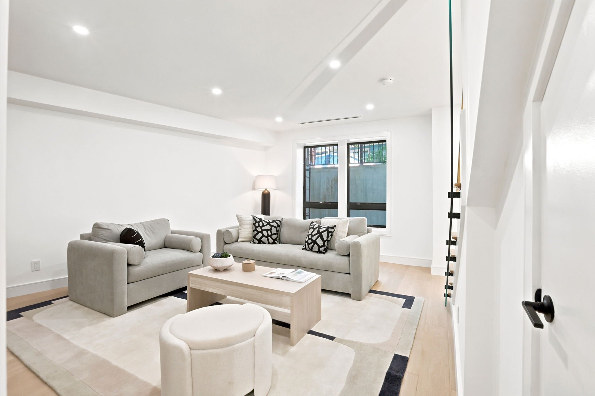 Living room with twin sofas beside the open staircase