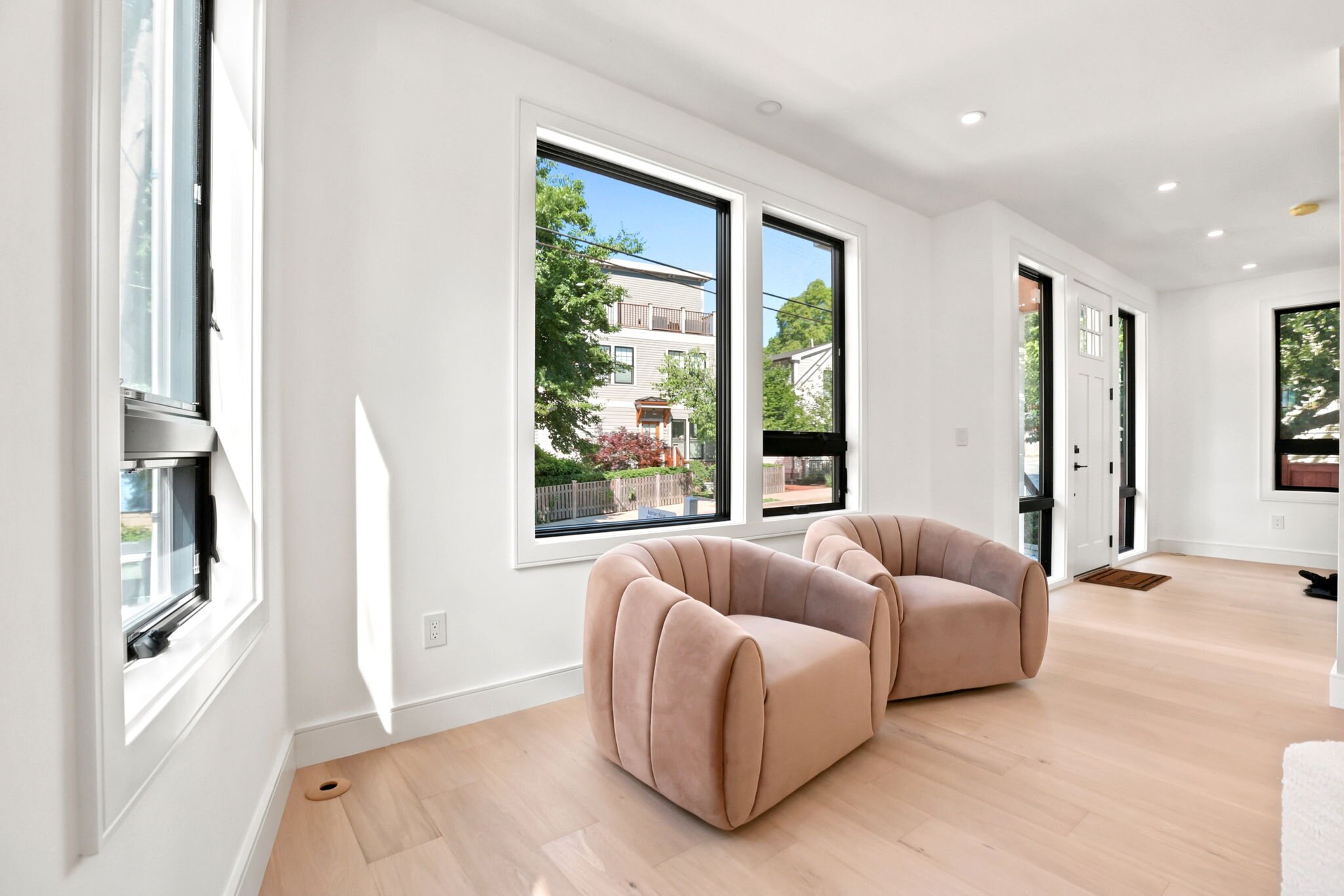 Open living room with a designer sectional and oversized windows