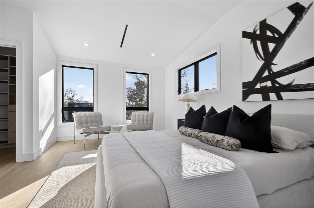 Primary suite sitting area with sculptural wall art