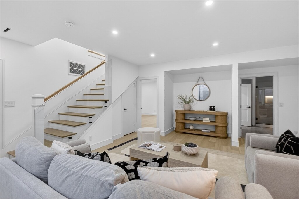 Living room beneath the sculptural open-riser staircase
